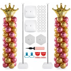 the balloon tower is decorated with gold and pink balloons, crowns, and other decorations