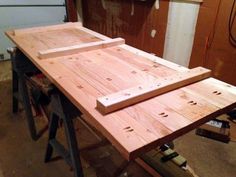 two pieces of wood sitting on top of a workbench