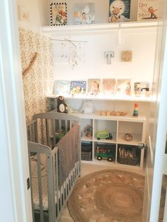 a baby's room with a crib and bookshelf