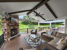 an outdoor living area with furniture and a fireplace