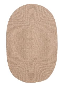 the oval rug in beige is shown on a white background