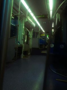 the inside of a subway car with its lights on and no people or vehicles in it