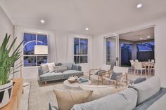 a living room filled with furniture and windows