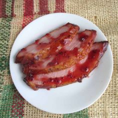 two pieces of bacon on a white plate