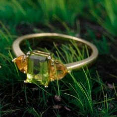 Transform Your Life with Our Three-Stone Heart Peridot & Citrine Ring Experience the powerful synergy of healing crystals with our exquisite Three-Stone Heart Peridot & Citrine Ring, crafted with care and intention. This beautiful piece is not just a ring; it's a source of emotional healing and positive energy. Specifications: Total Weight: 2.56g Stone Weight: 0.36g Silver Weight: 2.20g Main Stone Size: 5x7mm Shape/Pattern: Rectangle Setting Type: Prong Setting Metal Type: Yellow Gold and 925 St Natural Gemstones For Anniversary, Multi-stone Citrine Promise Ring, Citrine Multi-stone Promise Ring, Multi-stone Citrine Rings For Promise, Promise Ring With Citrine Birthstone, Citrine Birthstone Ring With Gemstone For Promise, Citrine Gemstone Birthstone Ring For Promise, Green Citrine Rings With Accent Stones, Green Citrine Gemstone Rings