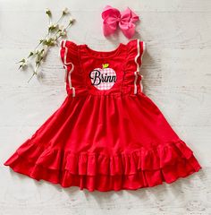 This listing is for the cutest red back to school dress!! Also Available in royal blue!! This is a cute ruffled red pinafore style dress. **This has a cute pink plaid VINYL apple with your choice of a personalized name or no name. You can also choose monogram initials.This is running true to size maybe slightly generous on top and hits to the knee or a little above. (See last picture for fit.) I think this could be paired with red ruffled shorties for a complete outfit or cute leggings. Last pic Cute Sleeveless Pinafore Dress For Playtime, Cute Short Sleeve Twirl Dress With Ruffles, Cute Ruffled Short Sleeve Twirl Dress, Cute Twirl Dress With Ruffle Hem And Flutter Sleeves, Cute Sleeveless Pink Pinafore Dress, Cute Pink Sleeveless Pinafore Dress, Preppy Pink School Dress, Cute Summer Pinafore Dress For Playtime, Cute Ruffle Sleeve Dress For Playtime