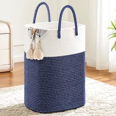 a large blue and white basket sitting on top of a rug