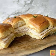 two sandwiches cut in half on a cutting board