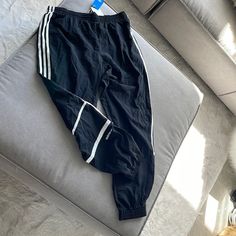 Black Men’s Adidas Running Pants With White Stripes. Brand New Adidas Joggers With Pockets For Streetwear, Adidas Sporty Black Bottoms, Sporty Black Adidas Bottoms, Adidas Trousers For Streetwear, Black Adidas Athleisure Joggers, Adidas Black Athleisure Joggers, Adidas Black Sweatpants For Streetwear, Adidas Casual Black Bottoms, Adidas Black Sporty Pants