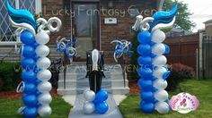 an entrance to a house decorated with blue and white balloons