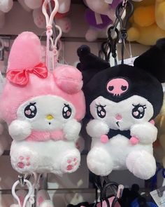 two hello kitty stuffed animals hanging from hooks