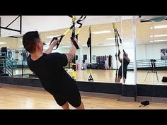 a man is doing exercises in the gym with resistance straps on his hands and feet