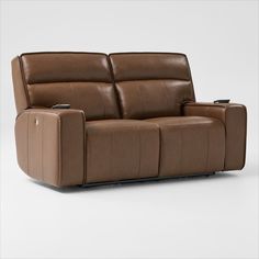 a brown leather reclining sofa sitting on top of a white floor