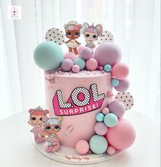 a pink cake decorated with lol dolls and balloons