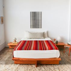 a bed sitting in a bedroom on top of a wooden platform