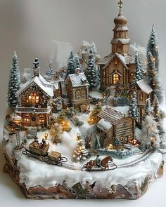 a christmas village is displayed on a white surface