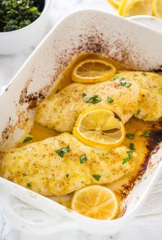 baked lemon pepper chicken breast in a white casserole dish