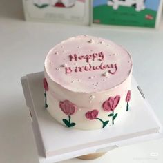 a birthday cake sitting on top of a white box