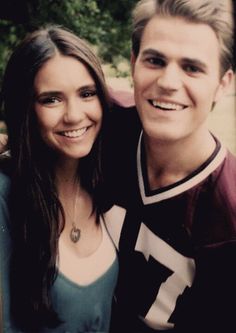 a young man and woman posing for a photo