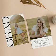 two graduation announcement cards sitting on top of a table