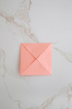 an origami envelope on a marble surface