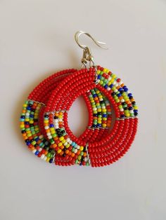 This listing is for ALL 11 pairs like shown above. The earrings are 100% handmade using original fine beads. Colorful and bright colors. ^^These earrings ships through dhl express. More earrings; https://www.etsy.com/shop/TribalTess?ref=seller-platform-mcnav&section_id=21293980 Buy multiple items and pay shipping for ONE item ONLY. Multicolor Hoop Earrings With Large Beads As Gift, Traditional Red Beaded Earrings With Colorful Beads, Traditional Multicolor Beaded Earrings, Traditional Colorful Round Bead Earrings, Traditional Multicolor Beaded Hoop Earrings, Multicolor Dangling Round Beads, Multicolor Round Dangling Beads, Traditional Multicolor Earrings With Polished Beads, Multicolor Large Beaded Round Earrings