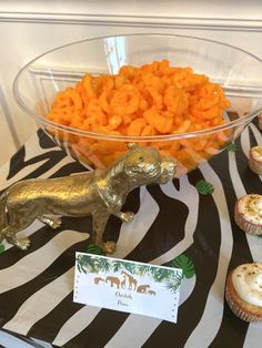 a table topped with cupcakes and snacks