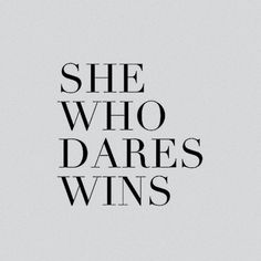 the words she who dares wins in black and white