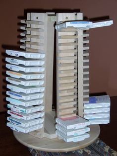 a stack of nintendo wii game controllers sitting on top of a table next to a pile of dvd's