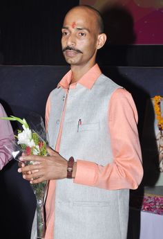 a man holding a bouquet of flowers in his hand