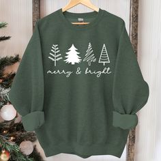 Christmas Tree Sweatshirt, Womens Christmas Sweatshirt, Christmas Sweater, Christmas Crewneck, Holiday Sweaters for Women, Winter Sweatshirt Suitable for many occasions such as Christmas, Father's Day, Mother's Day, birthday This classic crew-neck sweatshirt is an essential basic item for anyone’s wardrobe. The ribbed cuffs on the sleeves and waist are reinforced, and the high-quality cotton ensure that anyone will enjoy this cuddly and cool sweatshirt for many moons to come. Preshrunk fleece kn Sweatshirt And Shirt Outfit, Sweaters For Women Winter, Vintage Christmas Sweaters, Holiday Sweaters, Preppy Christmas, Christmas T Shirt Design, Womens Christmas, Christmas Crewneck, Funny Christmas Shirts