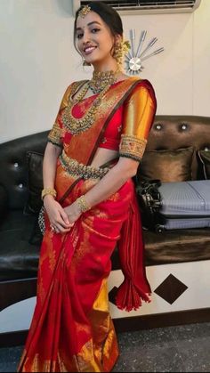 a woman in a red and gold sari