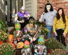 three women and two men dressed up as teenage mutant ninjas in front of a house