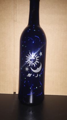 a blue glass bottle sitting on top of a table