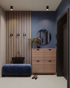 a room with blue walls and striped wallpaper on the walls, a wooden dresser in the foreground