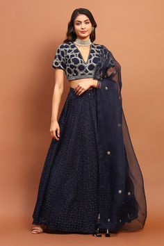 Navy blue attached cancan lehenga with thread, sequin embroidery in circle pattern. Paired with half sleeve padded blouse and dupatta. Components: 3 Pattern: Embroidery Type Of Work: Thread, sequin, circle Neckline: V neck Sleeve Type: Half Fabric: Georgette Color: Blue Other Details:  Tassel bordered sheer dupatta Occasion: Destination Wedding - Aza Fashions Traditional Chanderi Choli With Sequins, Semi-stitched Sequined Chanderi Lehenga, Chanderi Lehenga With Sequins, Unstitched, Fitted Chanderi Choli With Sequins, Designer Chanderi Lehenga With Sequins, Party Wear Art Silk Sequins Set, Party Wear Sequin Art Silk Sets, Blue Chanderi Lehenga For Party, Diwali Sequined Chanderi Lehenga