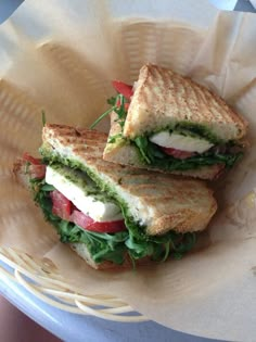 two sandwiches sitting on top of a paper plate