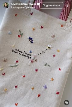 an embroidered bag with small butterflies on it