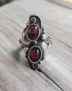 "Double garnet ring Beautifully detailed solid sterling silver(925) It weights 8-9 gms (depending on the size ) Length measures 30mm (1 1/4\") The 6 x8 dark red garnet cabochon stones are NOT SET UNTIL SOLD. I can make this with turquoise ,green or black onyx, cryhsophase or amethyst (amethyst is more expensive ) If a larger size is required more silver is used therfore there will be a slight increase. pls contact me first. I can also make this in gold" Antique Handmade Rings In Antique Silver, Antique Handmade Silver Rings, Vintage Silver Flower Ring For Jewelry Making, Vintage Toe Ring For Jewelry Making, Ornate Handmade Antique Silver Rings, Handmade Antique Silver Vintage Rings, Handmade Ornate Antique Silver Rings, Bohemian Oval Hallmarked Rings, Handmade Vintage Antique Silver Rings