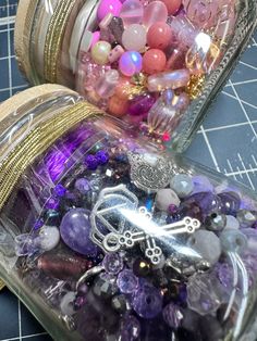 two glass jars filled with different types of beads