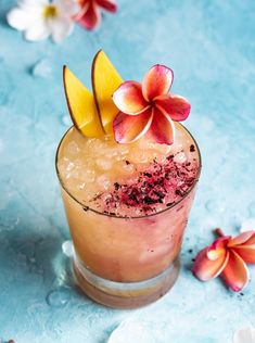 a drink with fruit and flowers on the rim