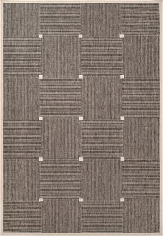 an area rug with squares and dots on the ground, in grey tones that appear to be made from wool