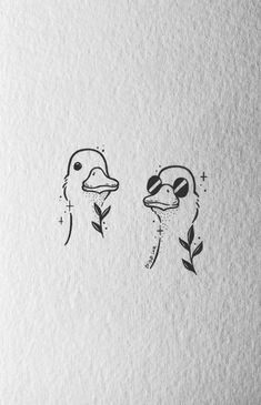 two birds with faces drawn in ink on paper