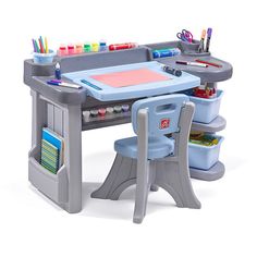 a child's desk and chair set with art supplies