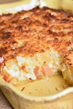 a casserole with cheese and meat in a yellow dish on top of a table