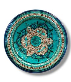 a blue bowl with an intricate design on it