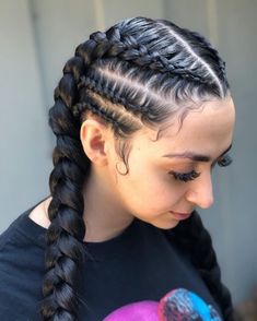 a woman with long braids holding a ball