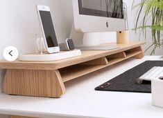 an apple computer sitting on top of a wooden desk