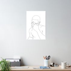 a drawing of a man covering his face with his hands while sitting on a desk