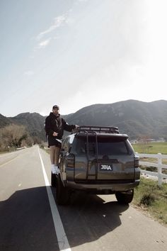 a man standing on the back of a truck